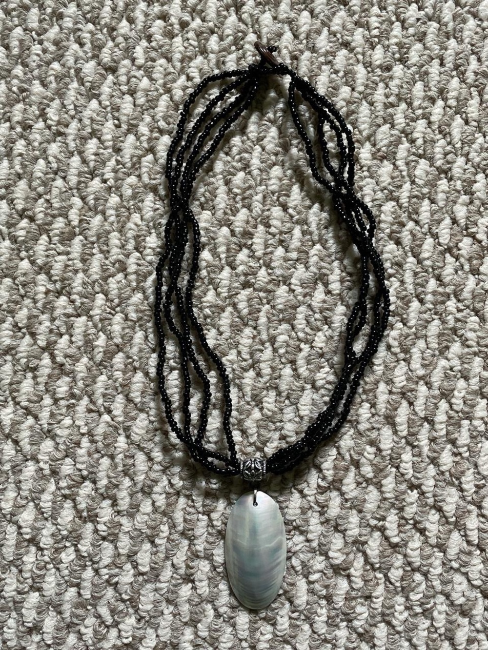Multi-Strand Black Beaded Necklace with Iridescent Shell Pendant